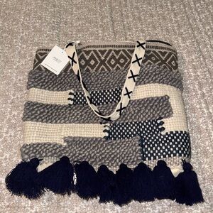 Jen and Co new with tag woven tote with a tassels at the bottom
